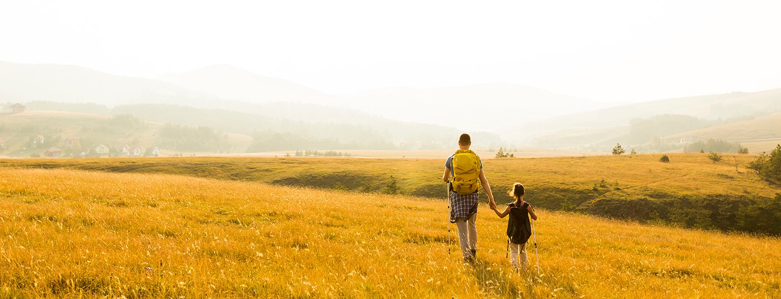 Father and daughter hiking together.